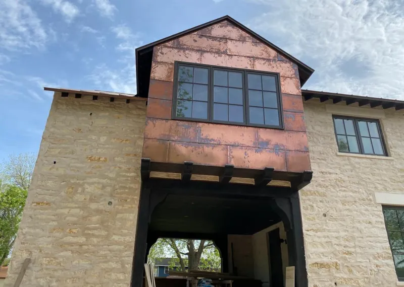 Copper metal panel facade on a stone building for Metal Roof Coating in Garden City